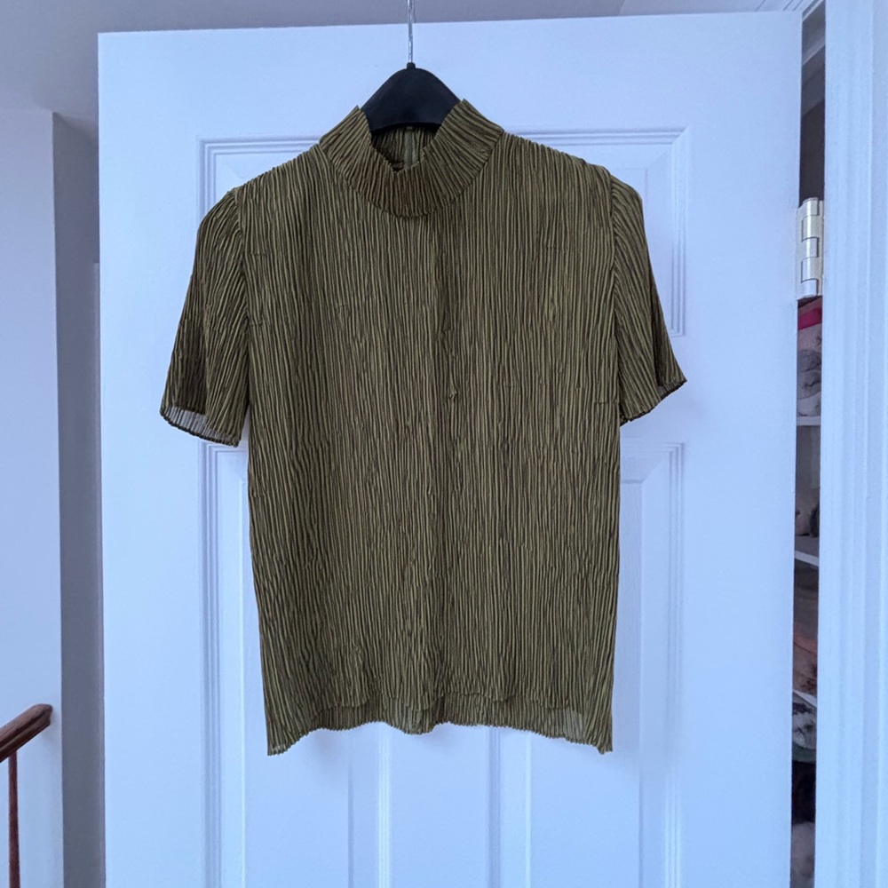 Made in Japan, this bean green pullover has a zipper at the back collar